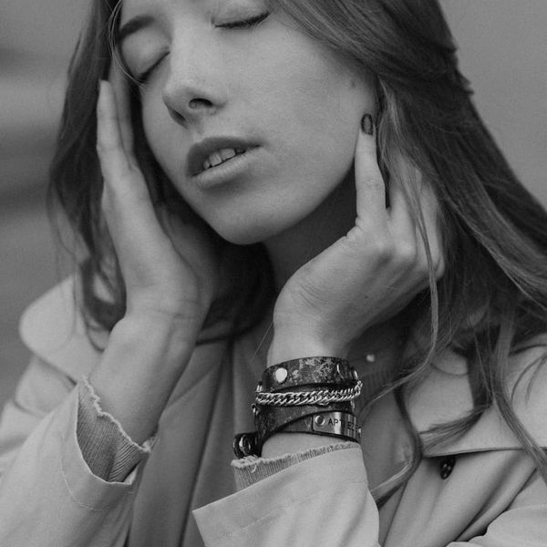Person meditating peacefully in a minimalist environment with soft lighting.